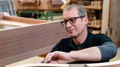 What does a carpenter do in the veneer department?